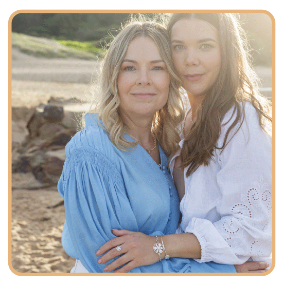 Portrait of Kati-Rose and Anne in front of seascape wearing Baltic Folk jewelry